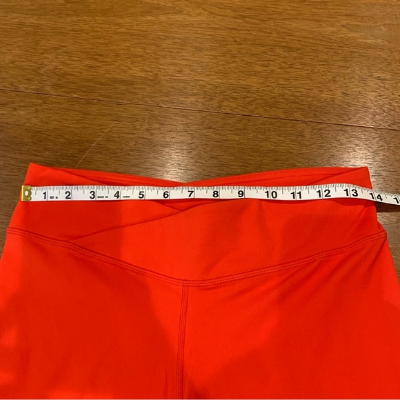 Fabletics Midrise Capris in orange with crossover waistband and hidden pocket - Picture 8 of 8